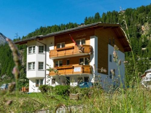 a building with balconies on the side of it at Apartment Amaryllis by Interhome in Saas-Grund