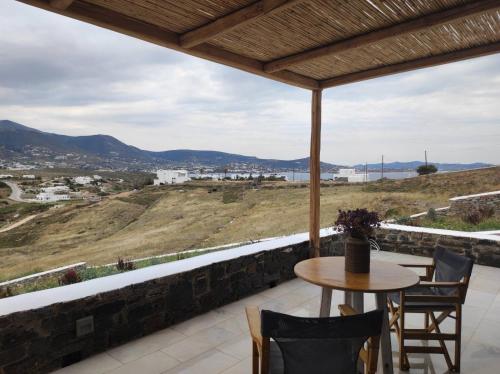 a balcony with a table and chairs and a view at Krotiri View Paros in Krotiri