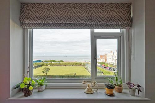 a window with a view of a green field at Walpole Bay Sea Views in Margate