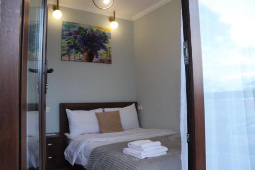 a bedroom with a bed with towels on it at Guesthouse Relax in Kazbegi in Stepantsminda