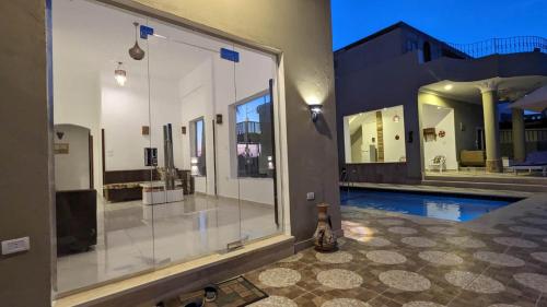 a house with a swimming pool and a large window at Yasmine Guest House in Luxor