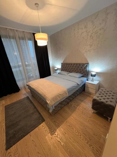 a bedroom with a king sized bed and a chair at THE GATES 201 in Belgrade