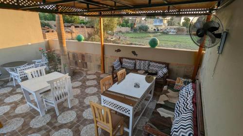 a patio with a table and chairs and a table and chairsearcher at Yasmine Guest House in Luxor
