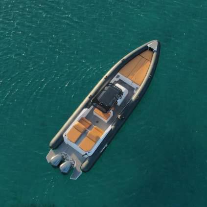 a small boat floating in the water at Elite Power Ribs in Mikonos