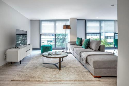a living room with a couch and a table at JVM 421, in Polanco by Blueground in Mexico City