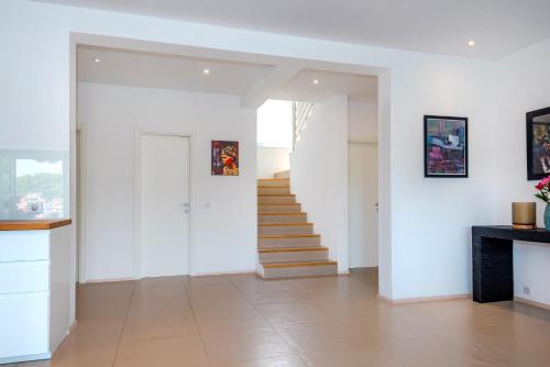 a hallway with white walls and stairs in a house at Marceline in Prvić Luka