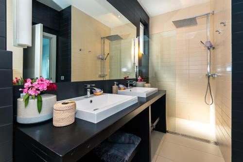 a bathroom with two sinks and a mirror at Marceline in Prvić Luka