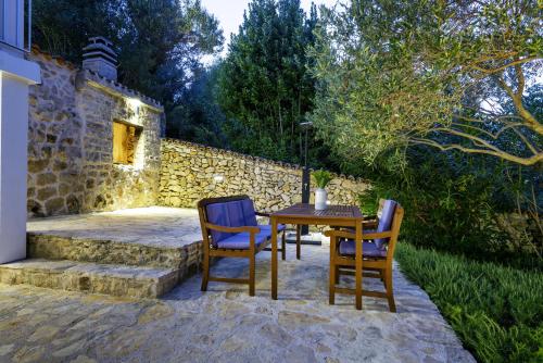 a table and chairs sitting on a patio at Marceline in Prvić Luka