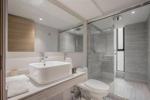a bathroom with a sink and a toilet and a shower at JVM 421, in Polanco by Blueground in Mexico City