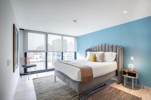 a bedroom with a large bed and a large window at JVM 421, in Polanco by Blueground in Mexico City