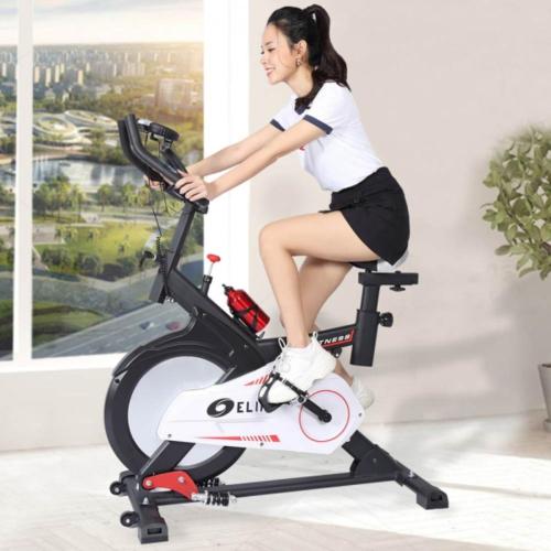 a woman riding on an exercise bike at Hai Trieu Hotel in Da Nang
