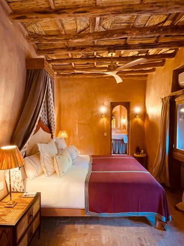 a bedroom with a large bed with a wooden ceiling at CASA ABRACADABRA in Marrakech