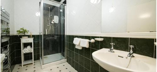 a bathroom with a sink and a shower at The Postgate Inn in Egton