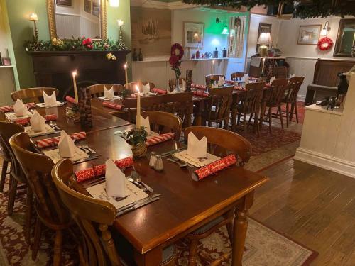 a dining room with a long table and chairs at The Postgate Inn in Egton
