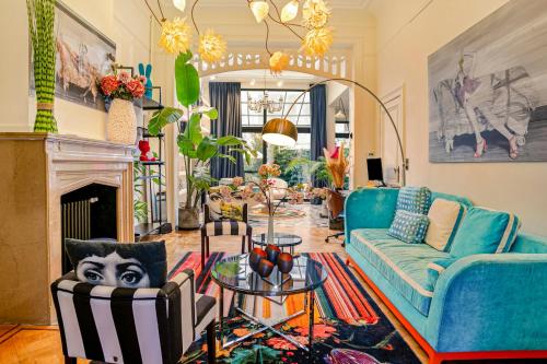 a living room with a couch and a table at Museum Garden View Apartment Antwerp South in Antwerp