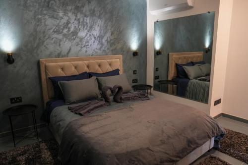 a bedroom with a large bed with a large mirror at Lux Sea&Country Views with Pool in Mellieħa
