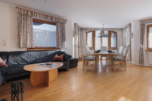 a living room with a couch and a table at Alpenvilla Winklwiese in Valdaora