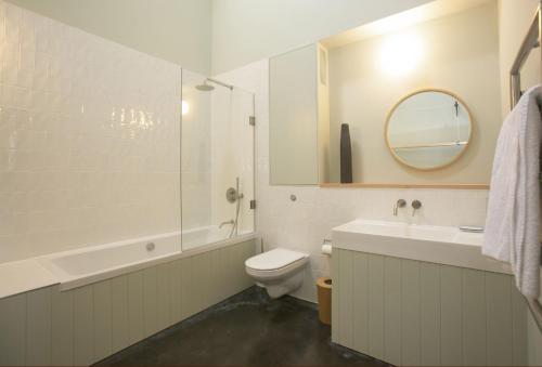 a bathroom with a toilet and a sink and a mirror at Lookout in Dorchester