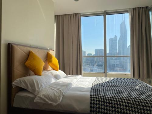 a bedroom with a bed with a large window at River House Near The Peoples Square And The Bund in Shanghai