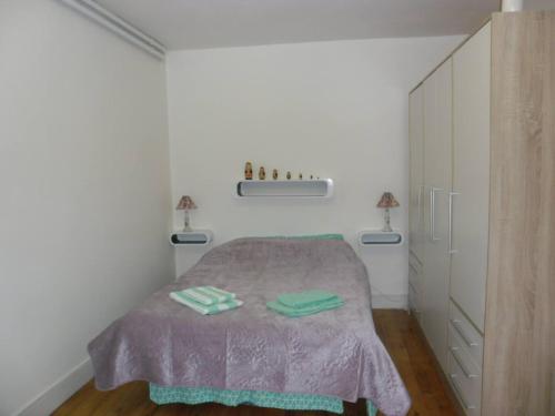 a bedroom with a bed with two towels on it at Meublé Bulgarana - 4 pers in Bourg-Argental
