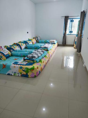 a row of beds sitting in a room at Villa Brastagi Gunung Mas Blok A1 in Berastagi