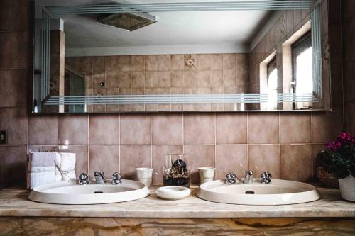 2 lavabos en un baño con un espejo grande en B&B Colle Vignoni, en Barberino di Mugello