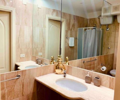 y baño con lavabo y espejo. en Appartamento Cagliari centro con vista sul porto, en Cagliari