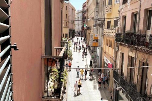 a group of people walking down a city street at Appartamento Cagliari centro con vista sul porto in Cagliari