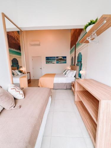 a hotel room with two beds and a mirror at Casa Cancun Hotel Boutique & Eventos in Penha