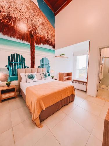 a bedroom with a bed and two blue chairs at Casa Cancun Hotel Boutique & Eventos in Penha