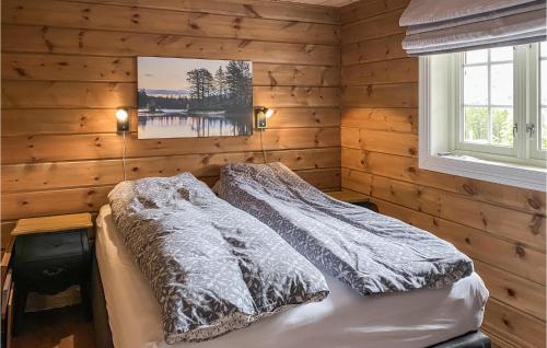 a bedroom with a bed in a wooden wall at 4 Bedroom Awesome Home In Nordfjordeid in Nordfjordeid