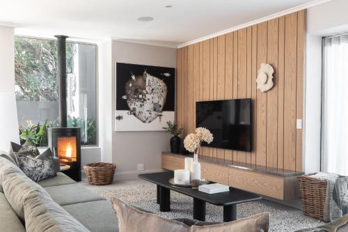 a living room with a couch and a tv at Escape to the Beach in Wilderness