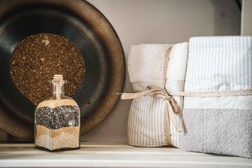 a bottle of soap next to towels and a bowl at B&B Colle Vignoni in Barberino di Mugello