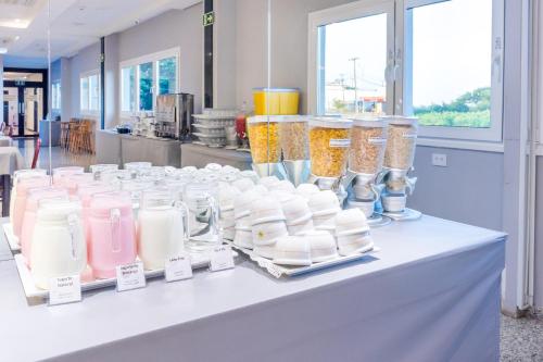 a white table with many glass jars on it at Luz Hotel by Castelo Itaipava in Foz do Iguaçu