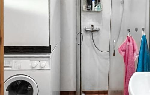 a kitchen with a washing machine and a refrigerator at 3 Bedroom Cozy Home In Backaryd in Backaryd
