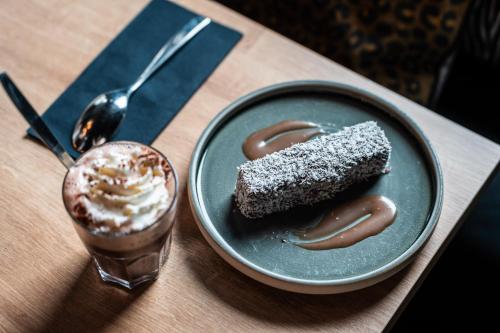 a plate with a piece of cake and a drink at Fahrenheit Seven Val Thorens in Val Thorens