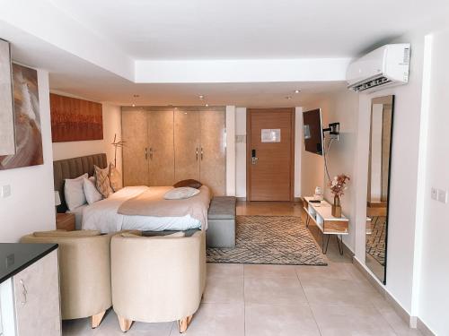 a hotel room with a bed and a bathroom at Sky Suites in Accra