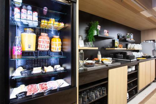 a refrigerator filled with lots of food and drinks at Hotel De Bourbon Grand Hotel Mercure Bourges in Bourges