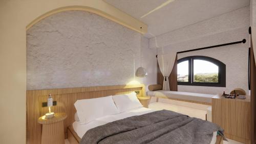 a bedroom with a white bed and a window at Unsal Hotel in Oludeniz