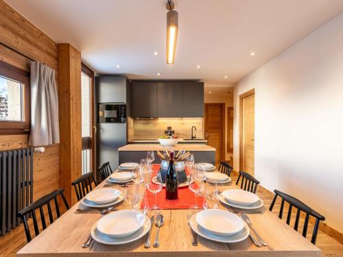 a dining room with a wooden table and chairs at Apartment Le Pramecou - Val Claret-8 by Interhome in Tignes