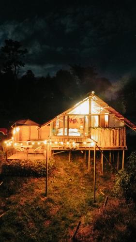 a house is lit up at night with lights at La Julita Glamping in La Mesa
