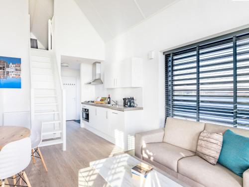 a living room with a couch and a table at Holiday Home Oesterdam Resort-1 by Interhome in Tholen