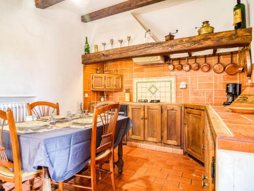a kitchen with a table and chairs in a room at Holiday Home Chez Canard by Interhome in Ampus