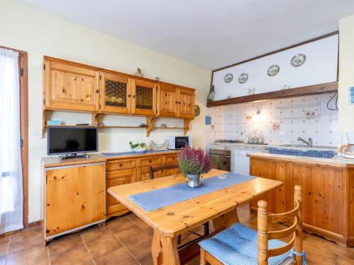 a kitchen with wooden cabinets and a wooden table at Holiday Home Ca de Isodor by Interhome in Glori