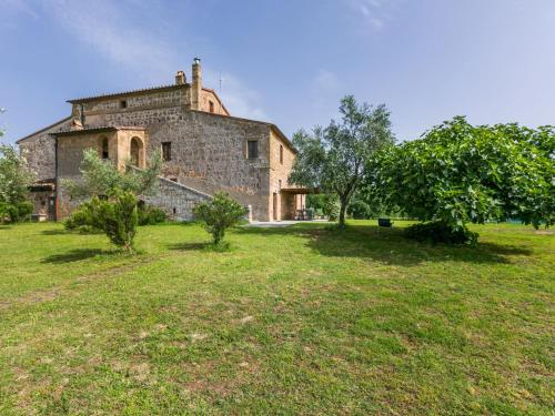 an old stone building in a field with trees at Apartment Malva by Interhome in Sorano
