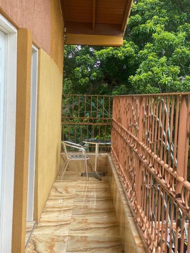 a balcony with a table and a chair on it at Montego Bay, Ironshore Luxury Studio in Montego Bay