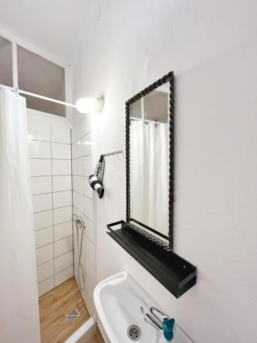a bathroom with a sink and a mirror on the wall at Cozy studio in Cracow in Krakow