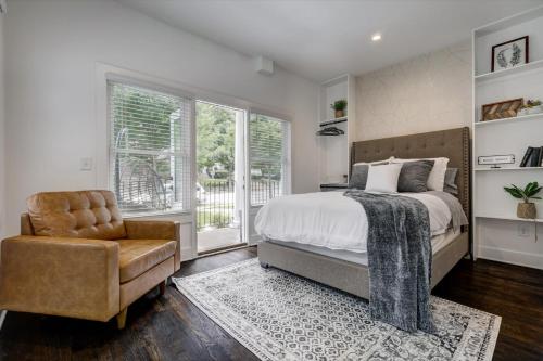 a bedroom with a bed and a chair and a window at Studio9Forty in Atlanta