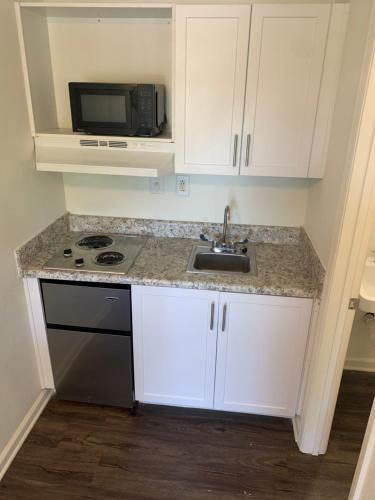 a kitchen with a sink and a microwave at My Town Extended Stay in Nashville