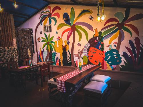a restaurant with a colorful mural on the wall at La Julita Glamping in La Mesa